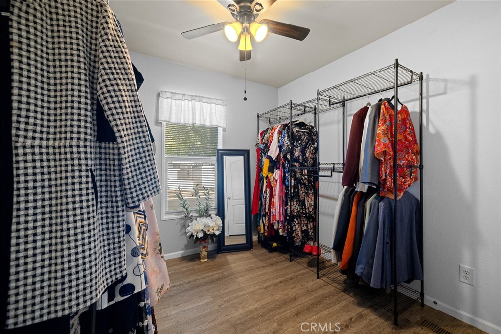 3524 East Avenue R, Unit 121 Palmdale, CA 93550 - Photo 15 of 40 a view of walk in closet with clothes