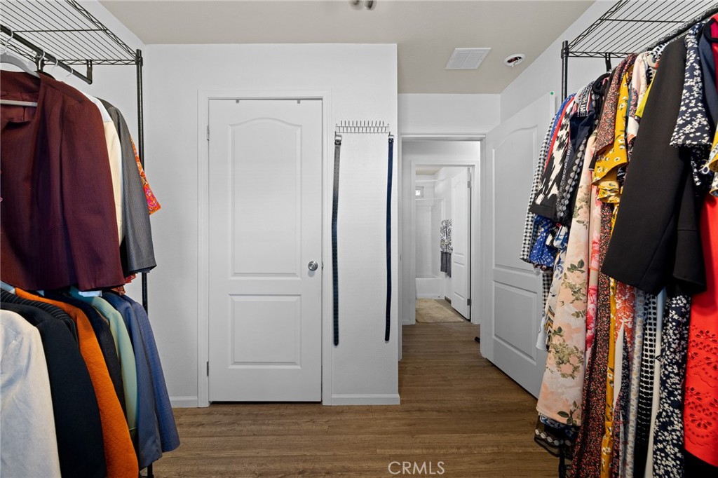 3524 East Avenue R, Unit 121 Palmdale, CA 93550 - Photo 16 of 40 a view of walk in closet with clothes and shoes