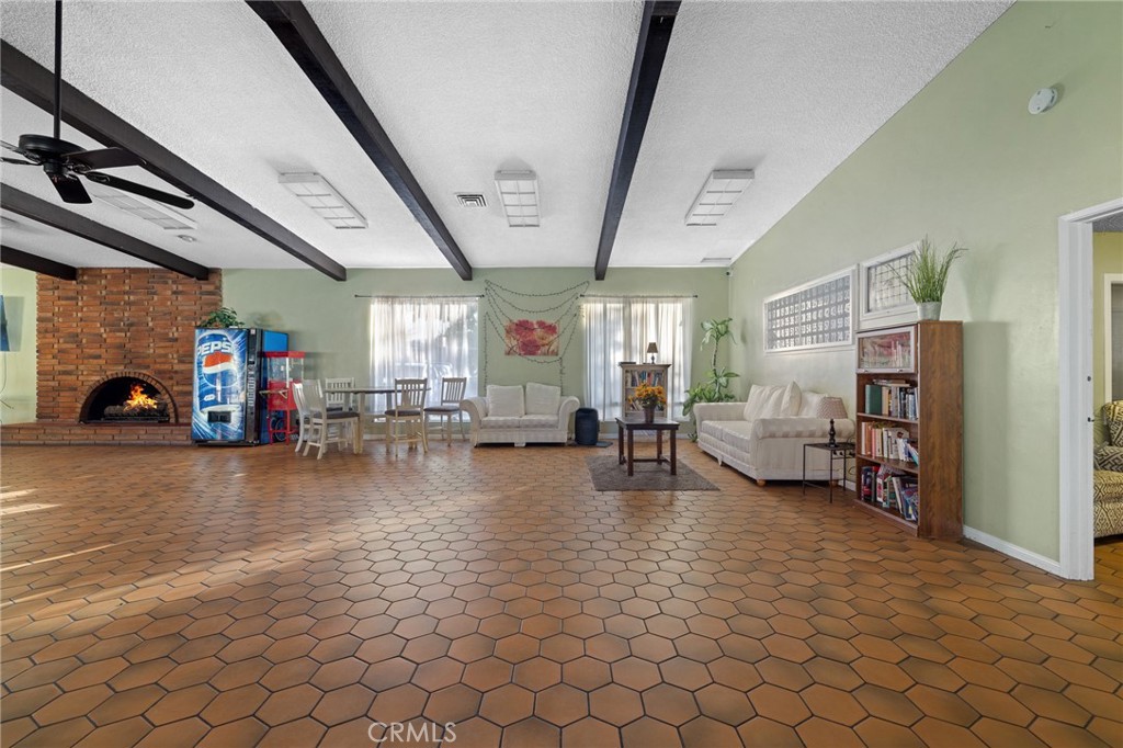 3524 East Avenue R, Unit 121 Palmdale, CA 93550 - Photo 29 of 40 a living room with furniture and a table