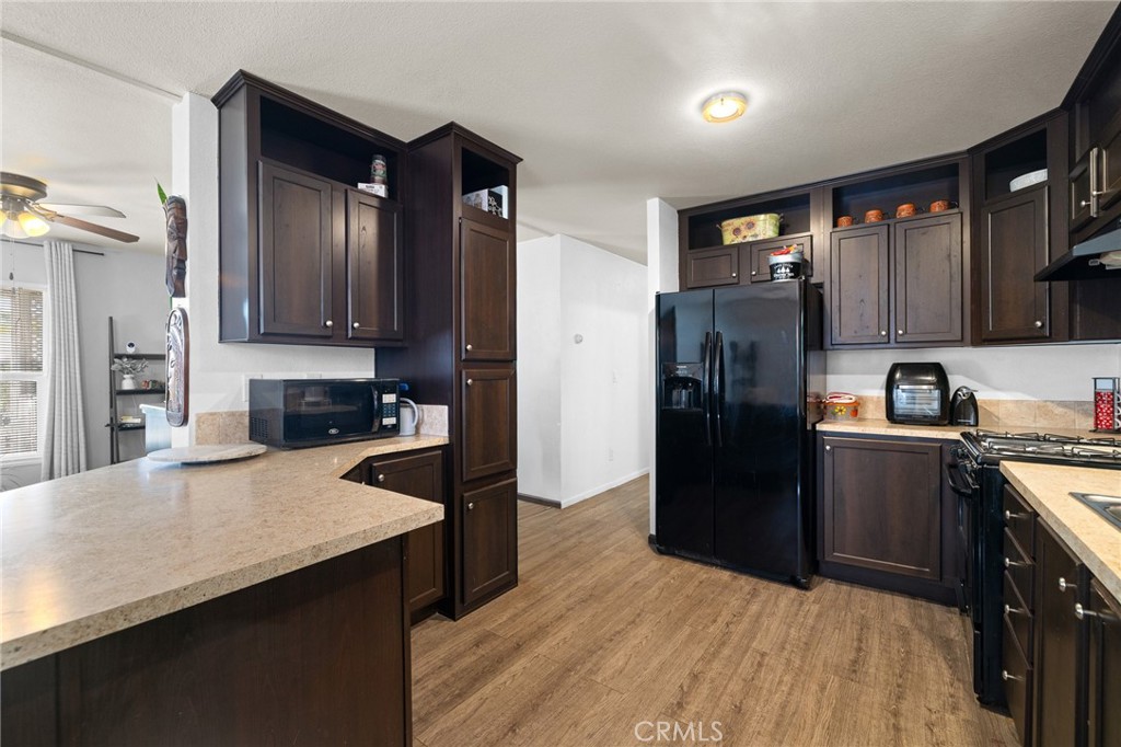 3524 East Avenue R, Unit 121 Palmdale, CA 93550 - Photo 3 of 40 a kitchen with stainless steel appliances a refrigerator and a stove top oven
