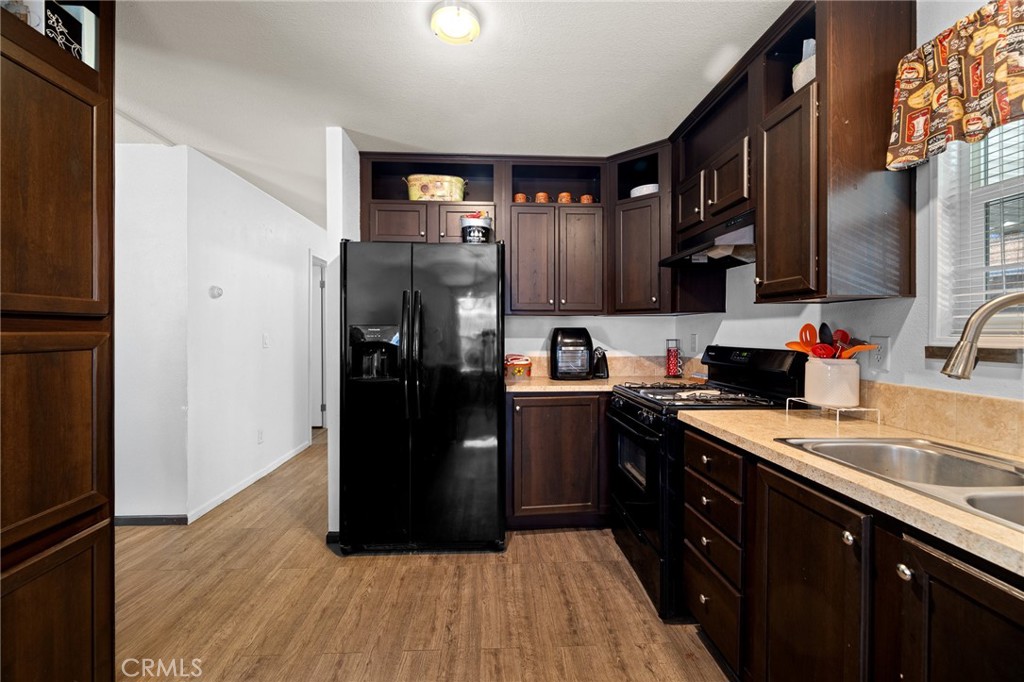 3524 East Avenue R, Unit 121 Palmdale, CA 93550 - Photo 5 of 40 a kitchen with a refrigerator and a sink