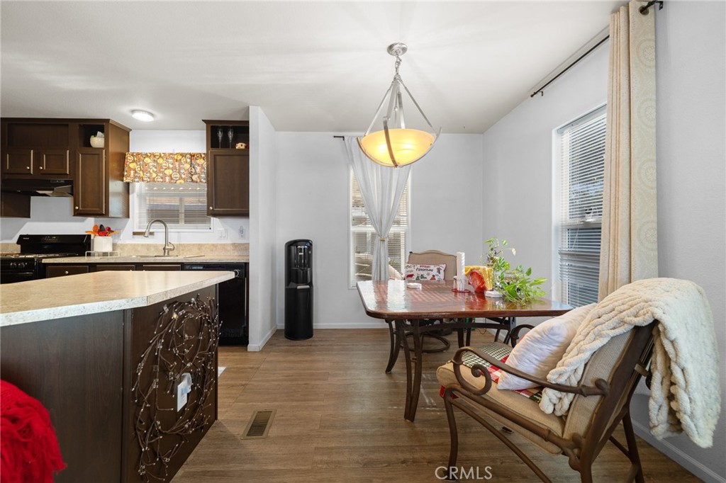 3524 East Avenue R, Unit 121 Palmdale, CA 93550 - Photo 8 of 40 a kitchen with a sink a stove and chairs