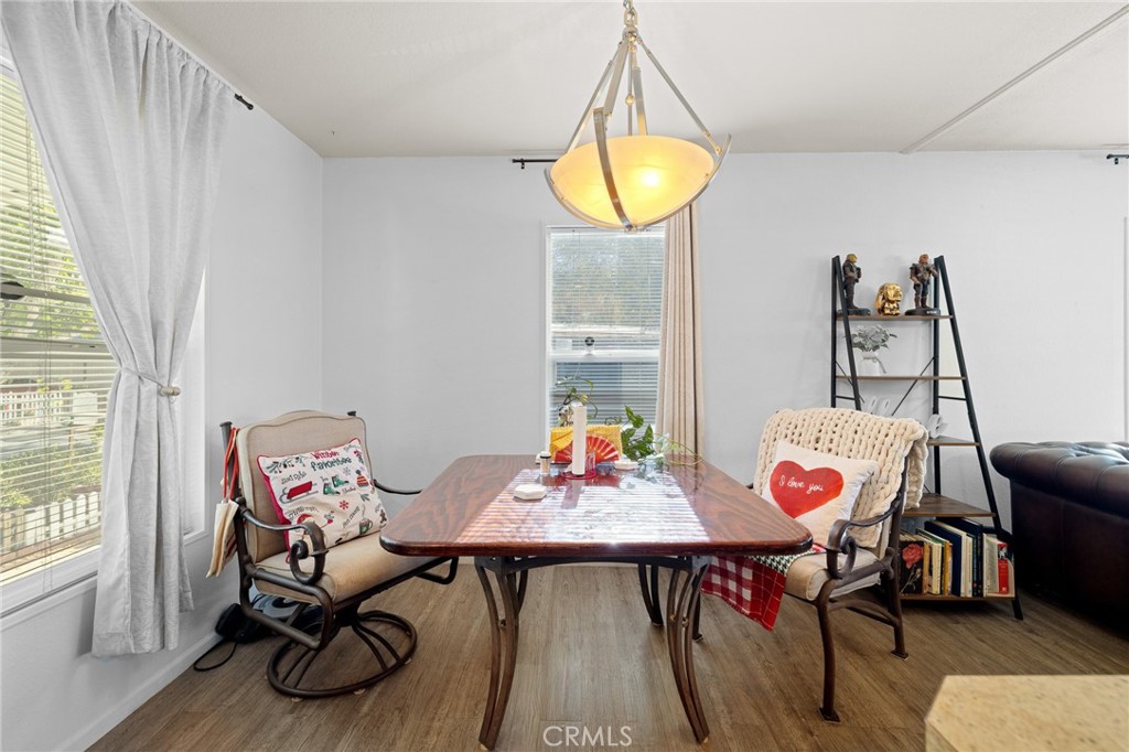3524 East Avenue R, Unit 121 Palmdale, CA 93550 - Photo 9 of 40 a view of a dining room with furniture and wooden floor