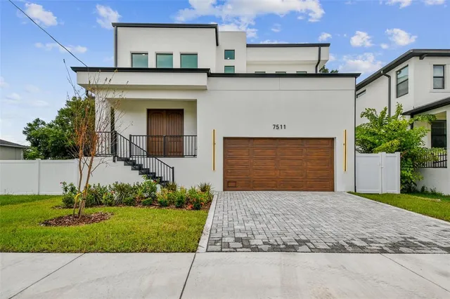 a front view of a house with a garden and plants