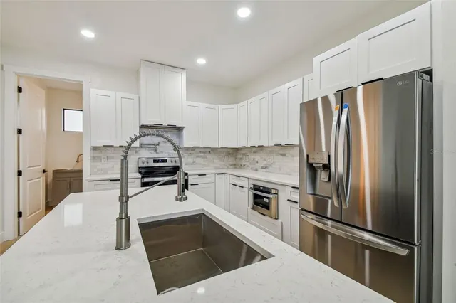 a hallway with wooden floor and windows