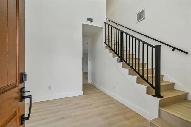a view of staircase with wooden floor and a window