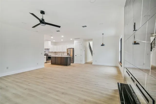 a kitchen with a sink stainless steel appliances and cabinets