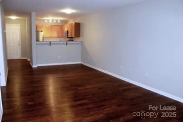 a view of a kitchen with wooden floor and a sink