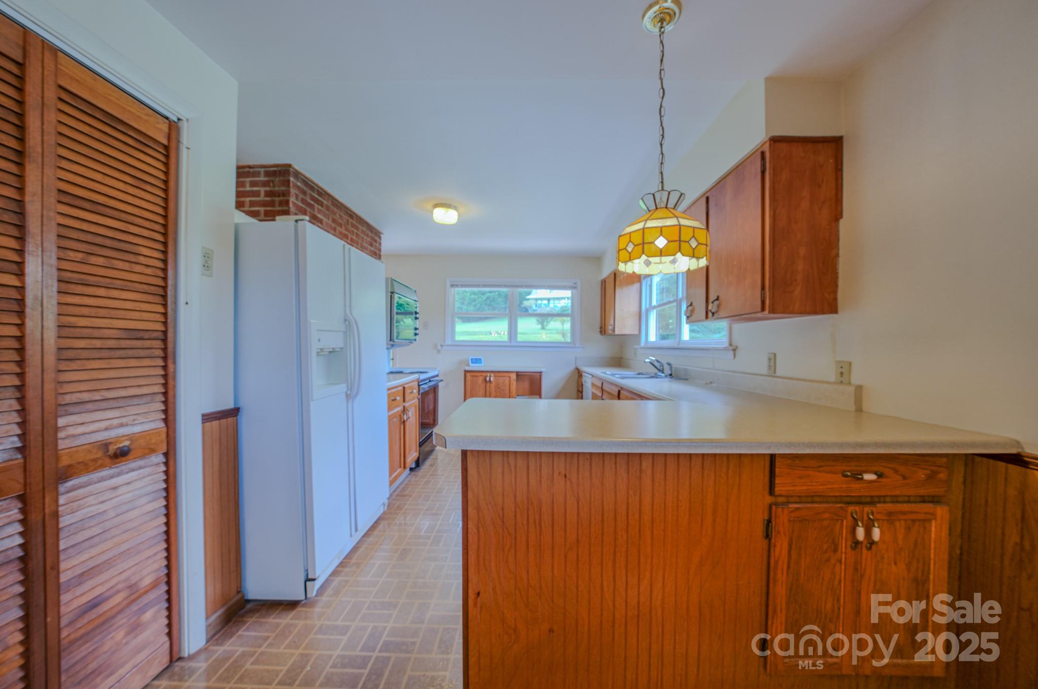 26 Big Cove Road Candler, NC 28715 - Photo 11 of 47 a kitchen with stainless steel appliances granite countertop a sink and a refrigerator