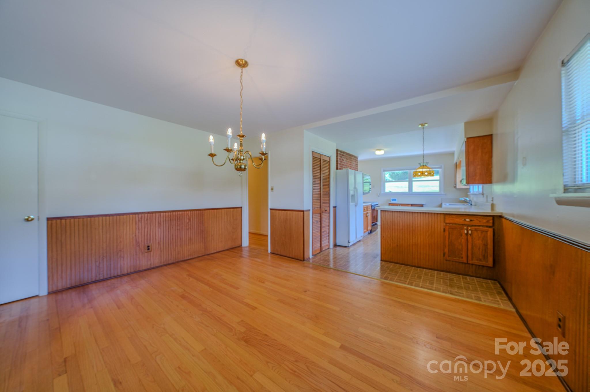 26 Big Cove Road Candler, NC 28715 - Photo 13 of 47 a view of a kitchen with a sink wooden cabinets and a refrigerator
