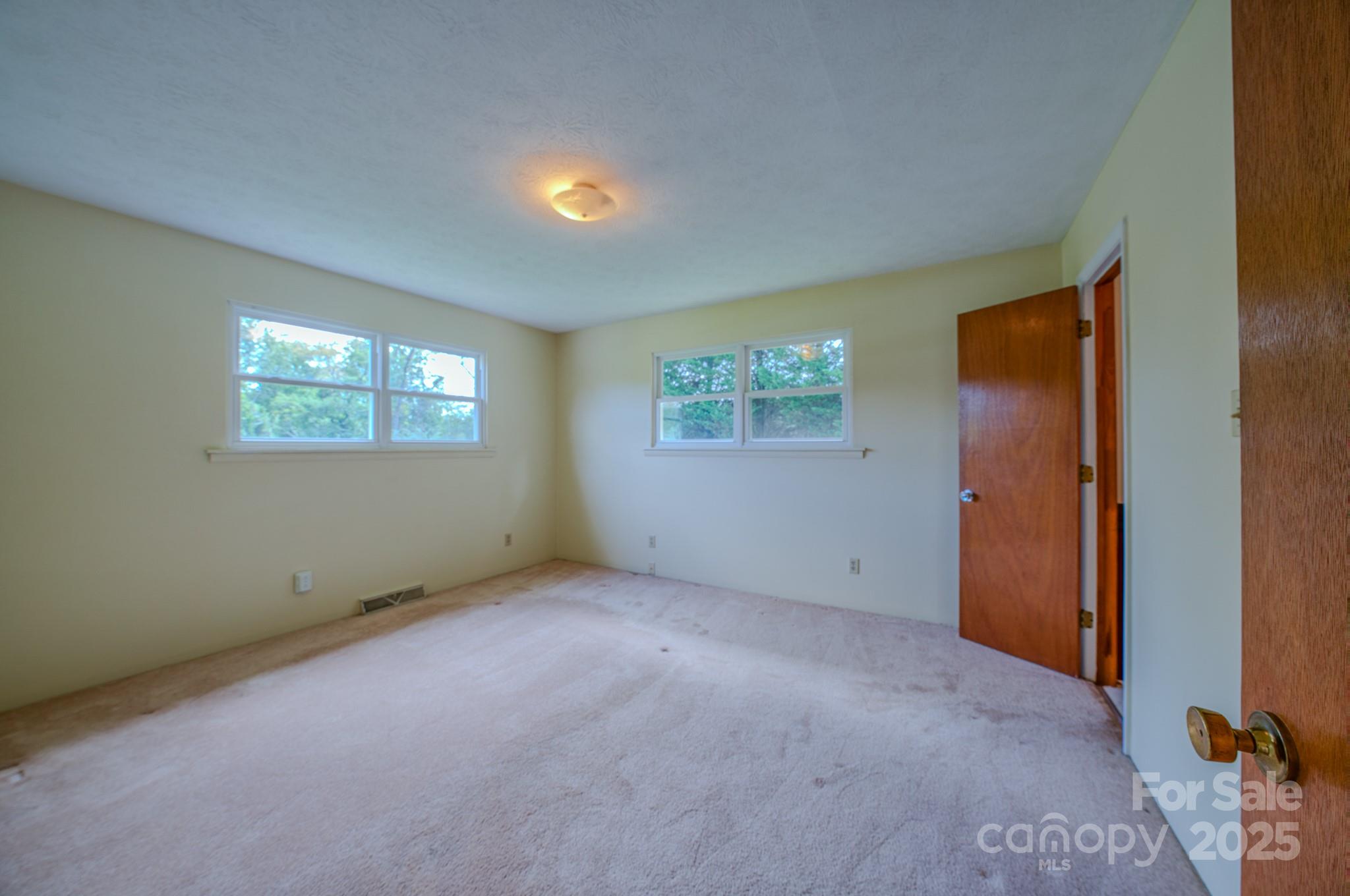 26 Big Cove Road Candler, NC 28715 - Photo 20 of 47 an empty room with windows