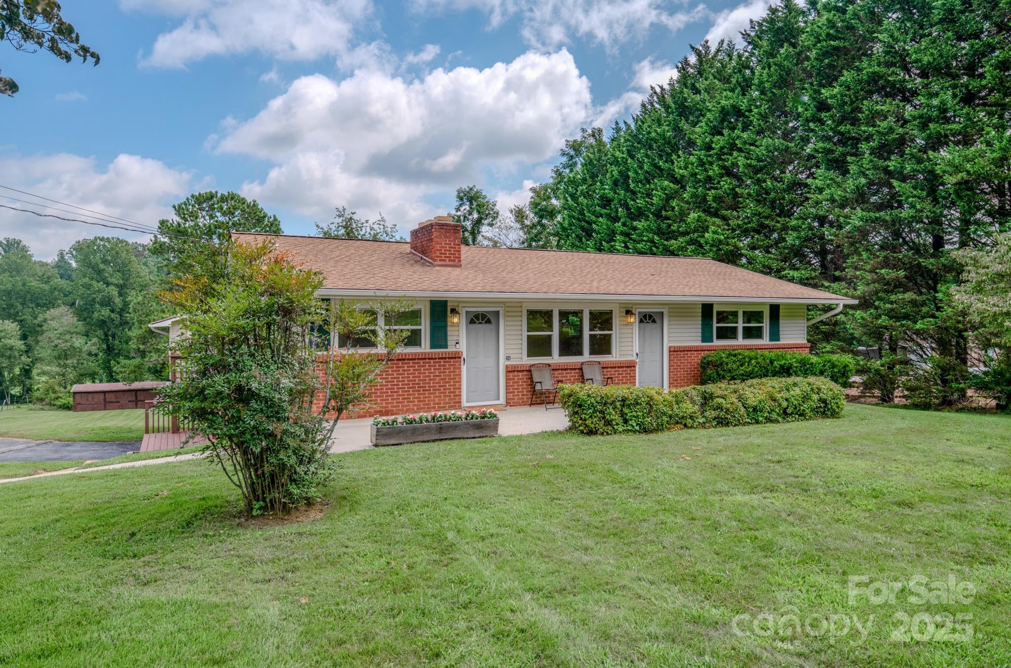 26 Big Cove Road Candler, NC 28715 - Photo 2 of 47 a front view of a house with garden