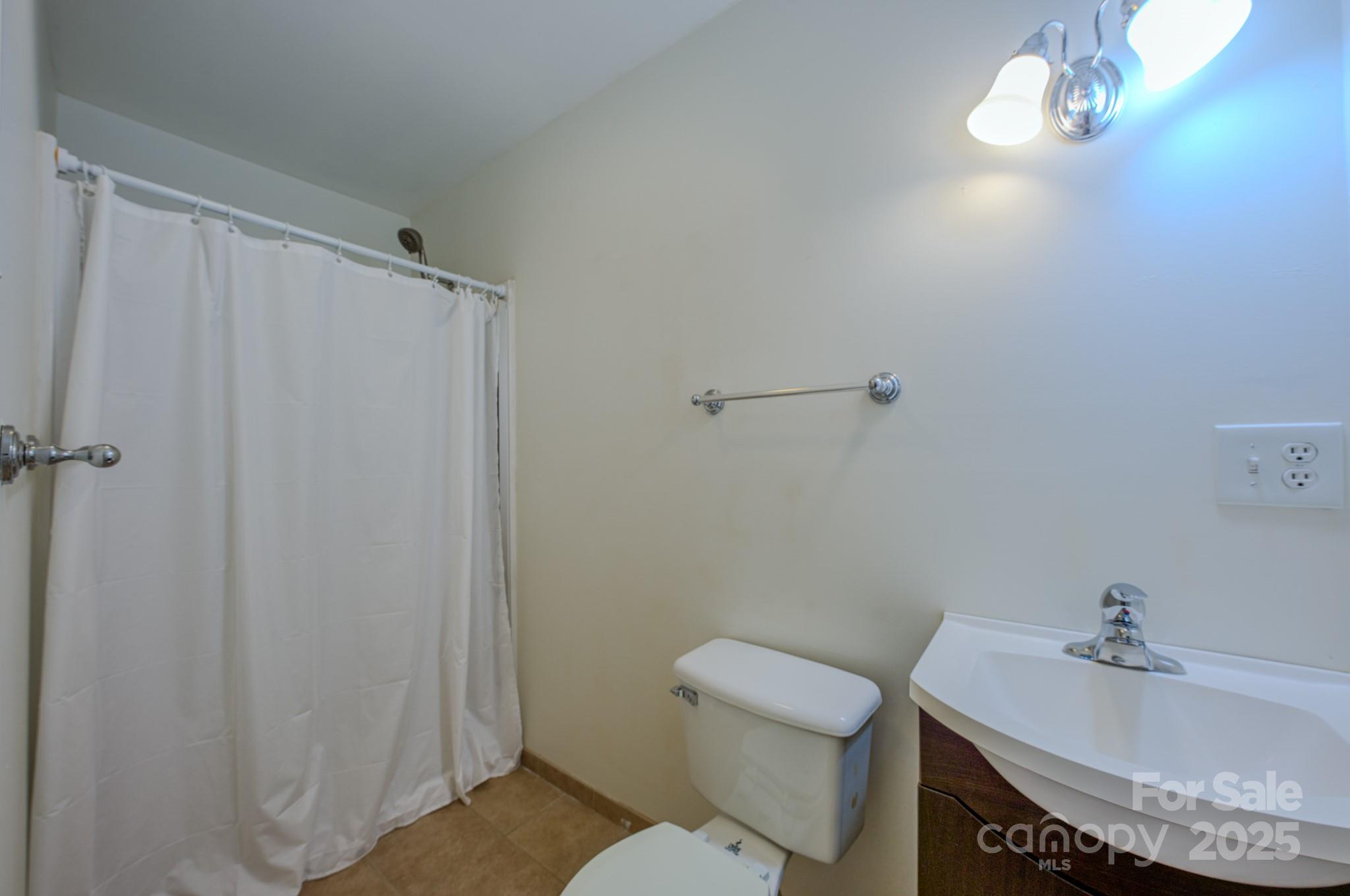 26 Big Cove Road Candler, NC 28715 - Photo 21 of 47 a bathroom with a sink and toilet
