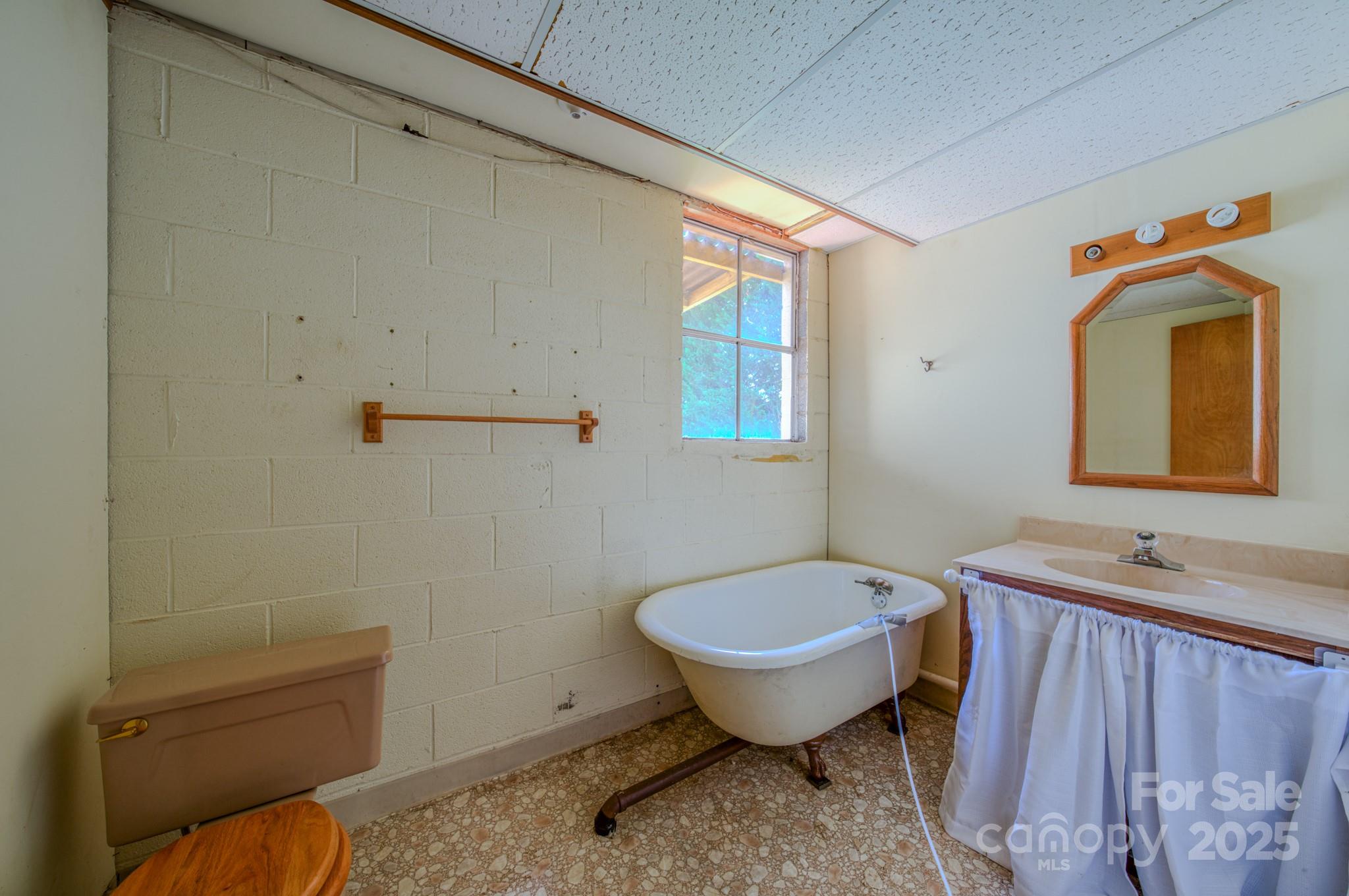 26 Big Cove Road Candler, NC 28715 - Photo 34 of 47 a bathroom with a sink toilet and shower