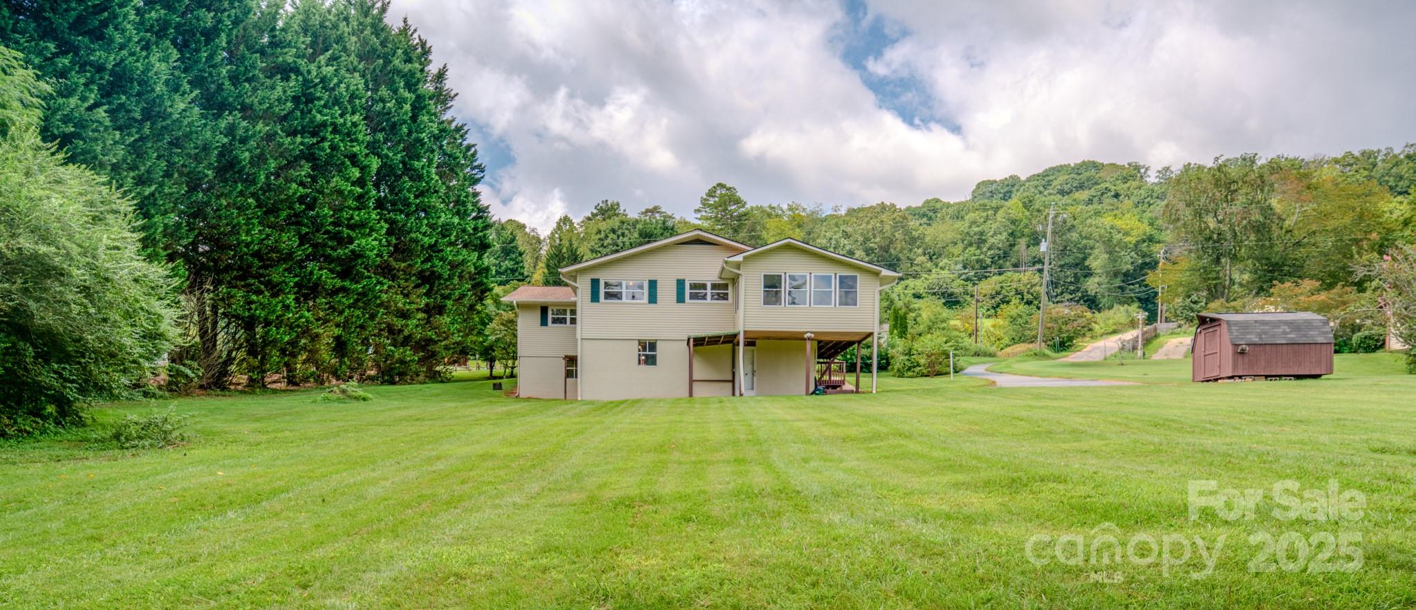 26 Big Cove Road Candler, NC 28715 - Photo 37 of 47 a view of a house with a yard and sitting area