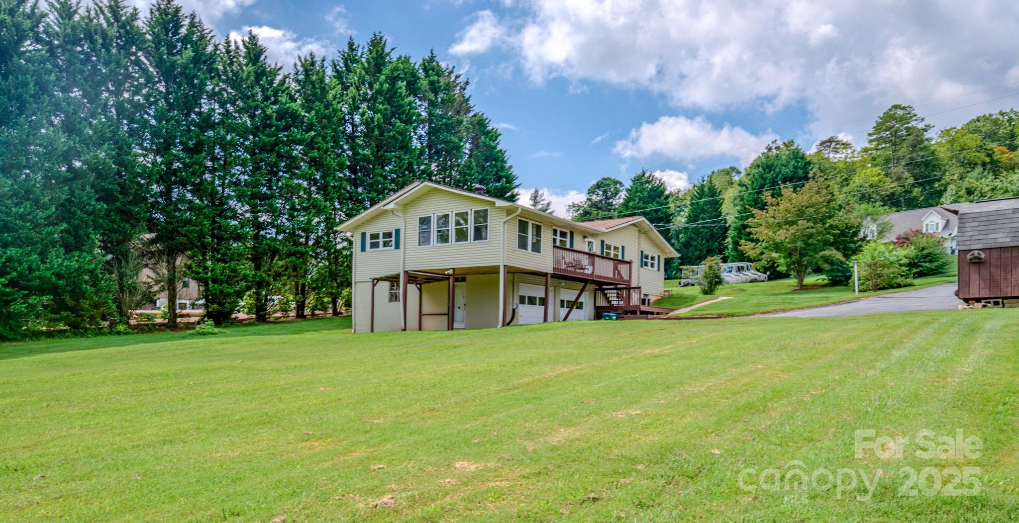 26 Big Cove Road Candler, NC 28715 - Photo 43 of 47 a view of a house with a big yard and large trees