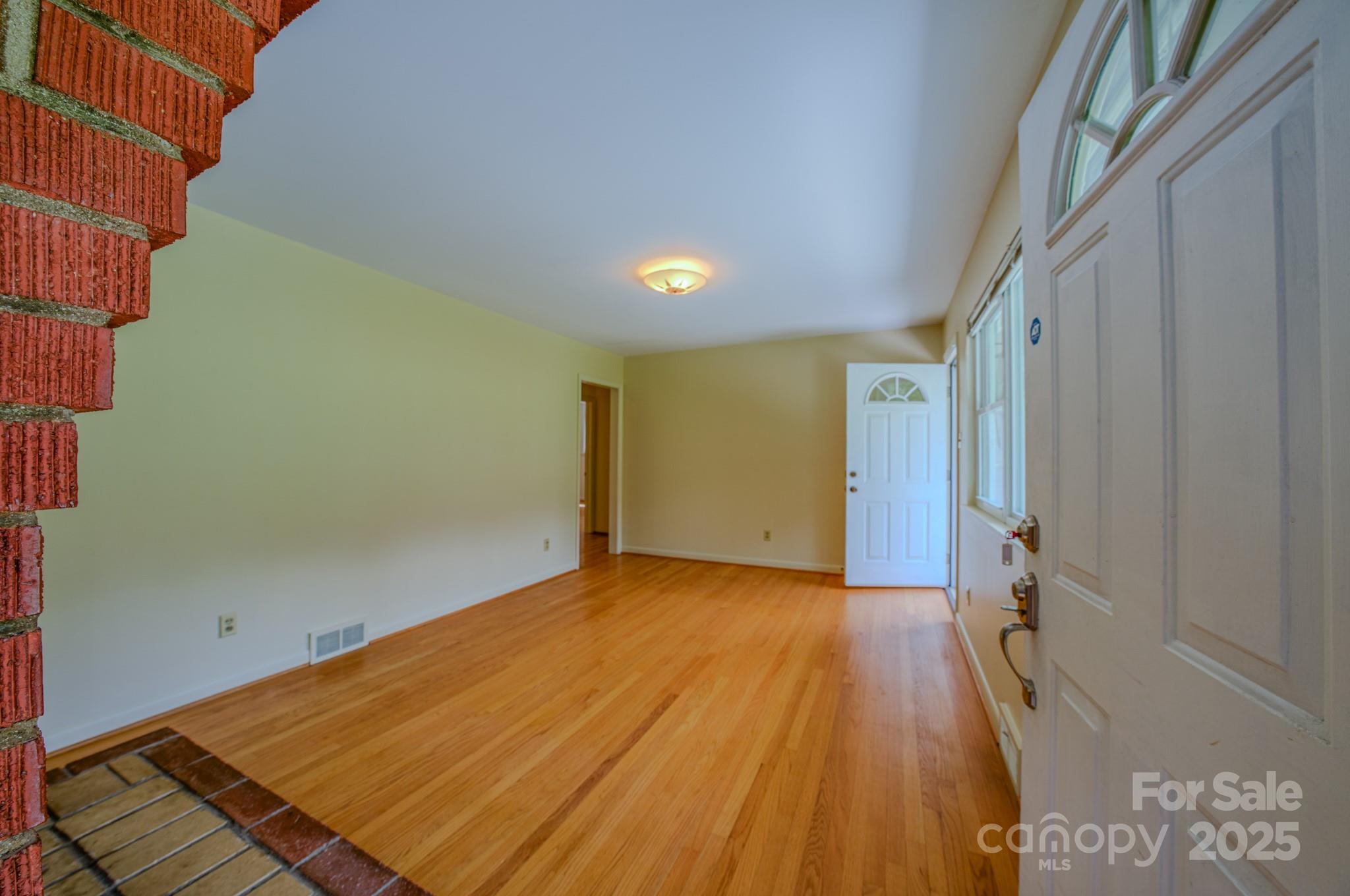 26 Big Cove Road Candler, NC 28715 - Photo 8 of 47 a view of a big room with wooden floor and windows