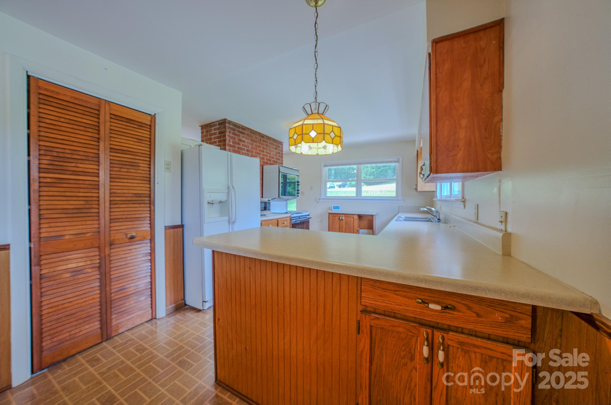 26 Big Cove Road Candler, NC 28715 - Photo 9 of 47 a kitchen with a sink cabinets and a window