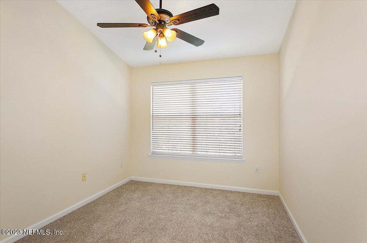 628 Crystal Way Orange Park, FL 32065 - Photo 19 of 21 an empty room with a window and a fan