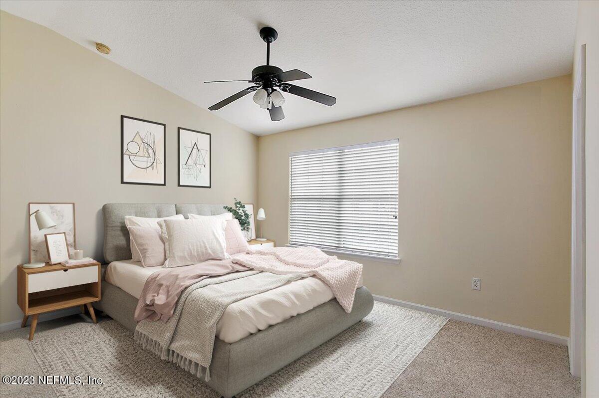 628 Crystal Way Orange Park, FL 32065 - Photo 8 of 21 a bedroom with a large bed and a window