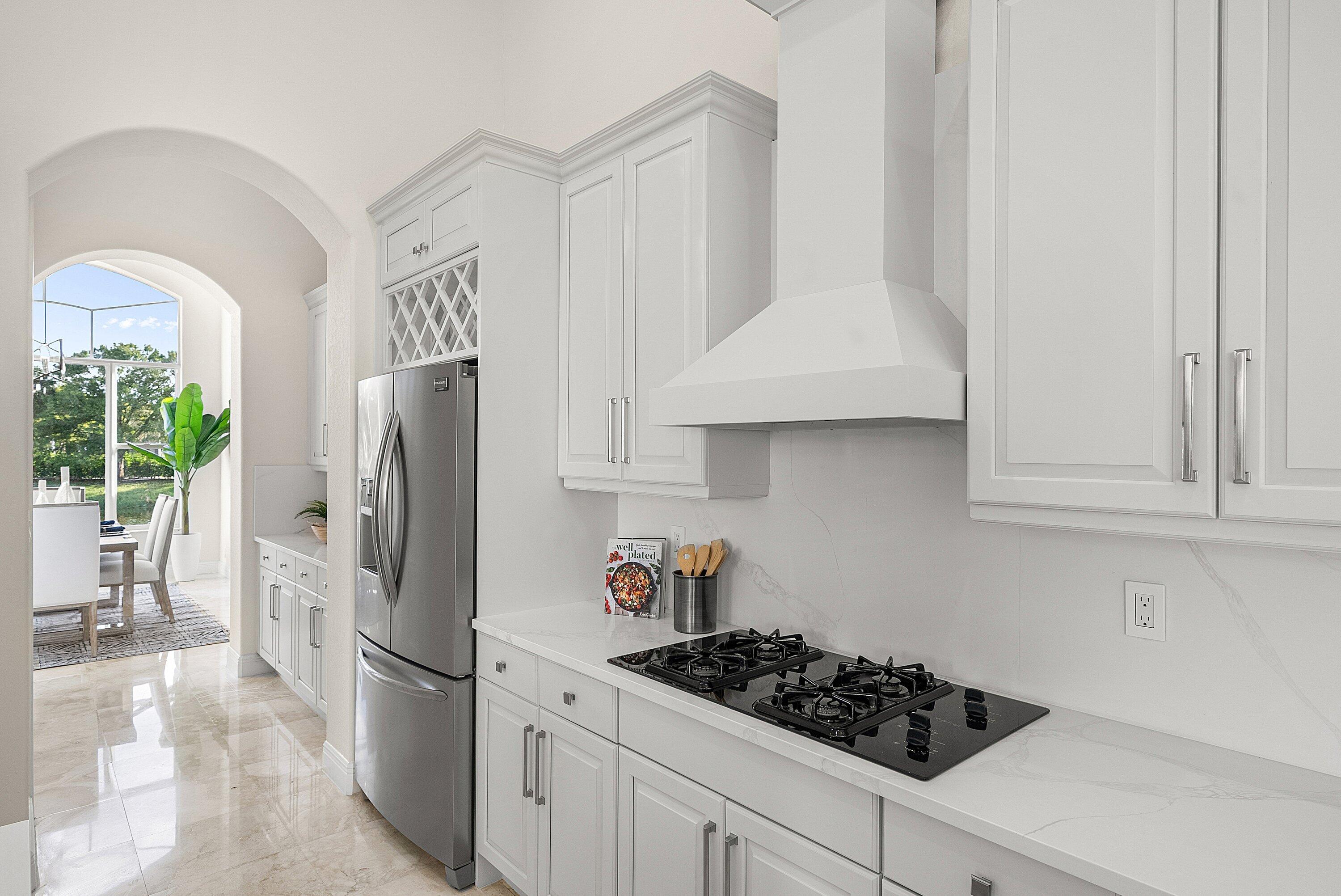 6468 Polo Pointe Way Delray Beach, FL 33484 - Photo 11 of 89 a kitchen with stainless steel appliances granite countertop a refrigerator and a stove