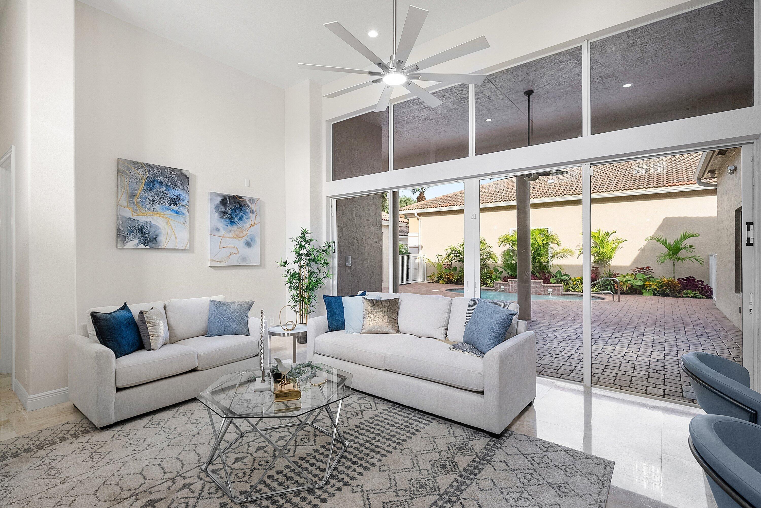 6468 Polo Pointe Way Delray Beach, FL 33484 - Photo 20 of 89 a living room with furniture and a large window