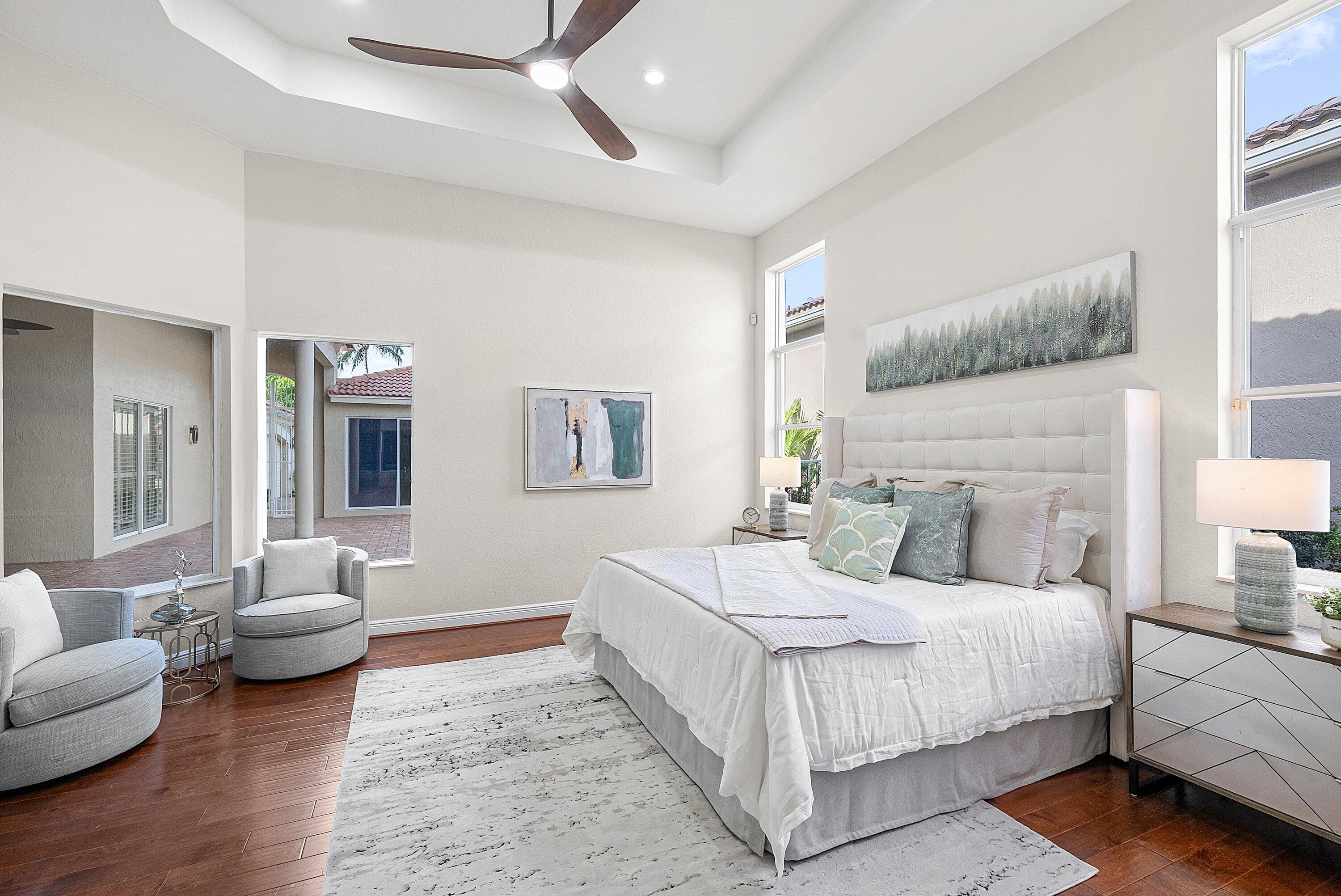 6468 Polo Pointe Way Delray Beach, FL 33484 - Photo 21 of 89 a bedroom with a white bed and a couch