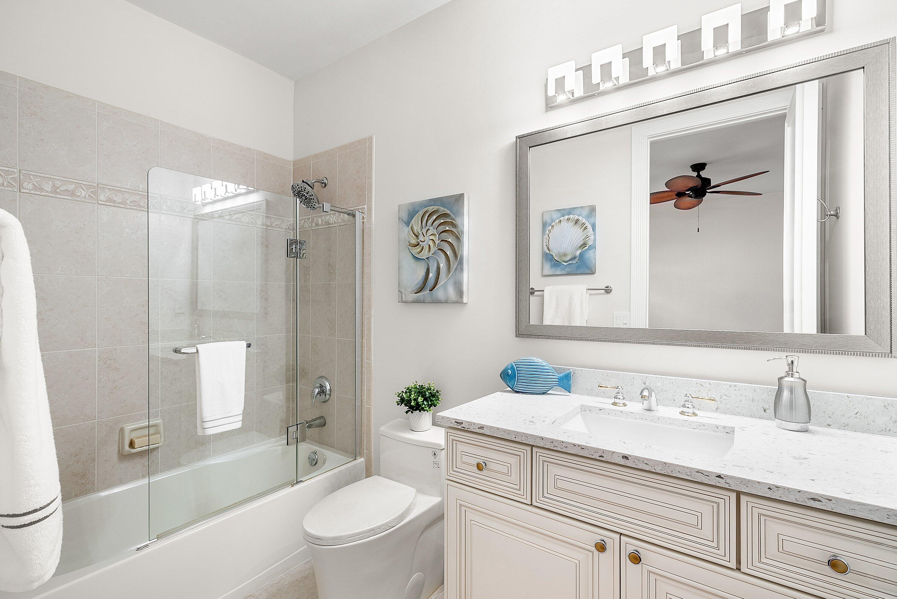 6468 Polo Pointe Way Delray Beach, FL 33484 - Photo 30 of 89 a bathroom with a granite countertop sink a toilet and a bathtub