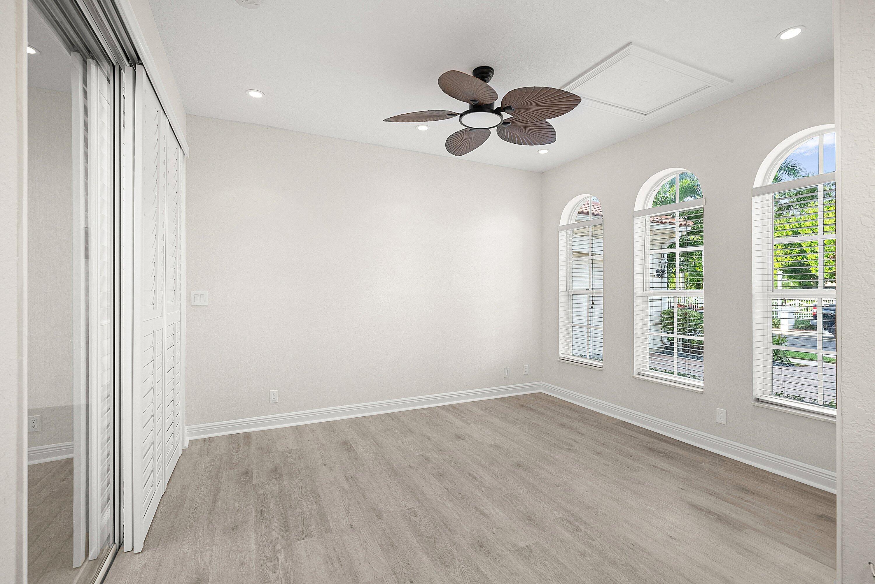 6468 Polo Pointe Way Delray Beach, FL 33484 - Photo 34 of 89 wooden floor in an empty room with a window