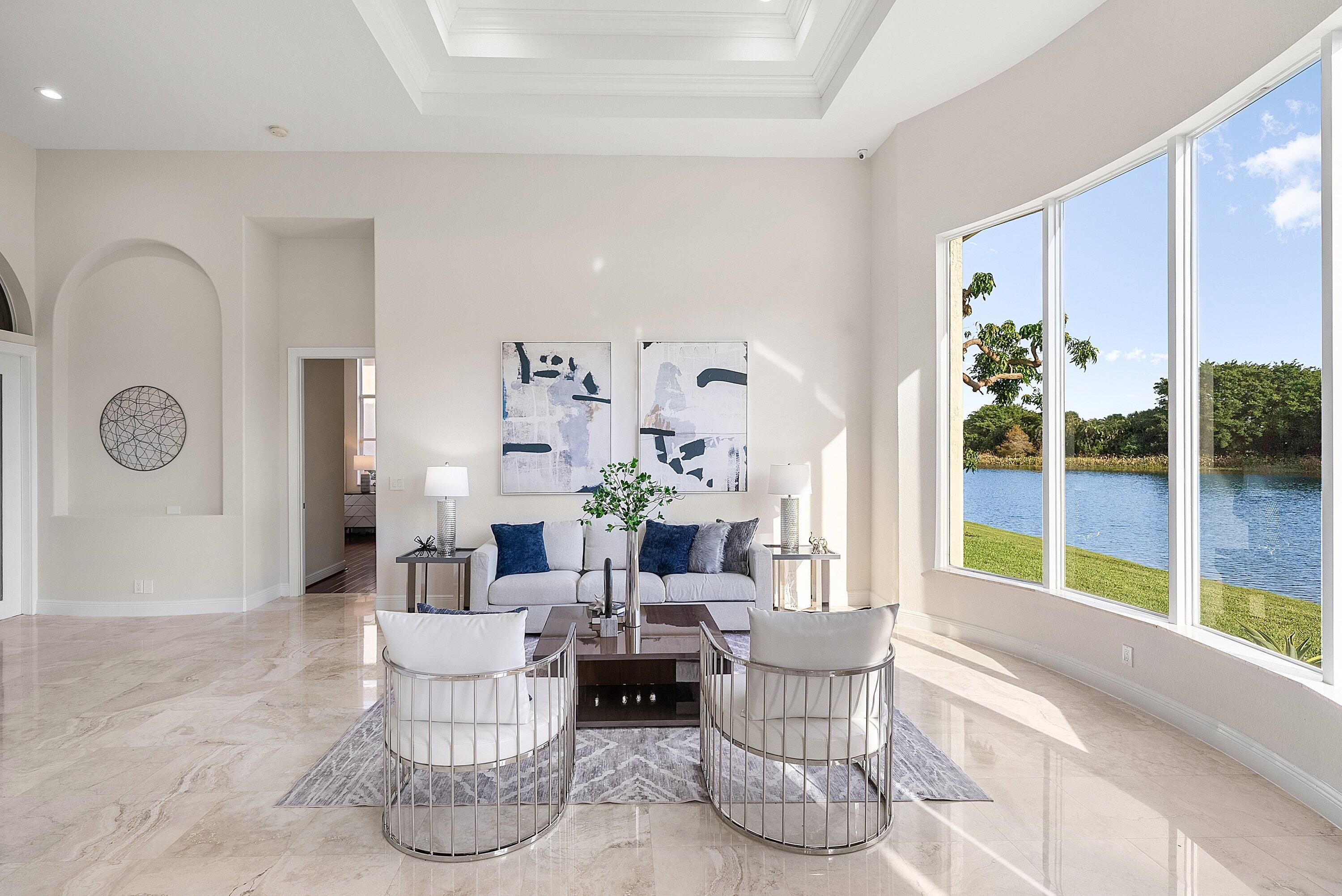 6468 Polo Pointe Way Delray Beach, FL 33484 - Photo 5 of 89 a living room with furniture and a large window
