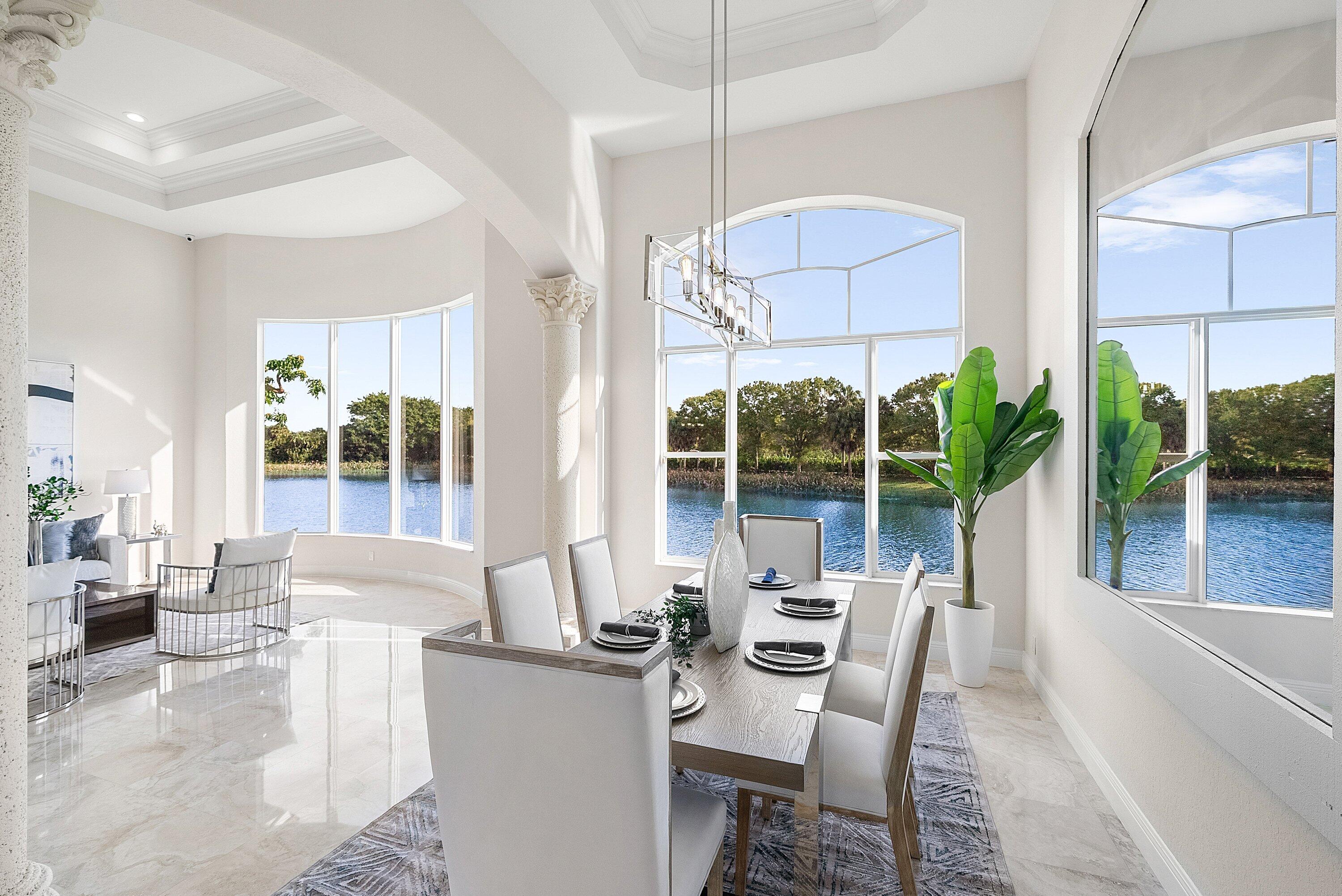 6468 Polo Pointe Way Delray Beach, FL 33484 - Photo 8 of 89 a dining room with furniture a chandelier and a large window