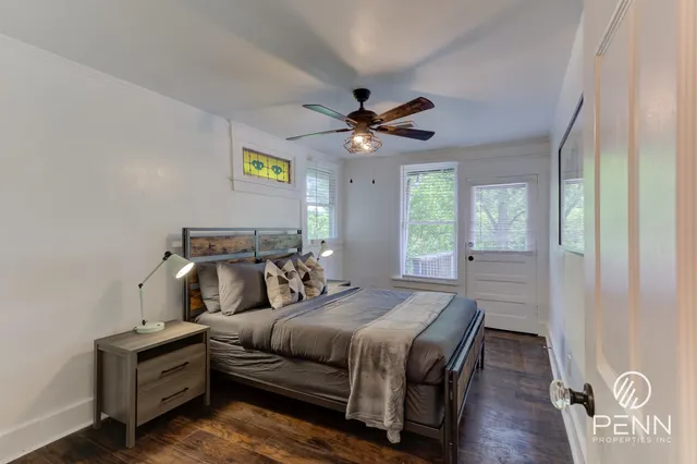 a bedroom with a bed and a chandelier