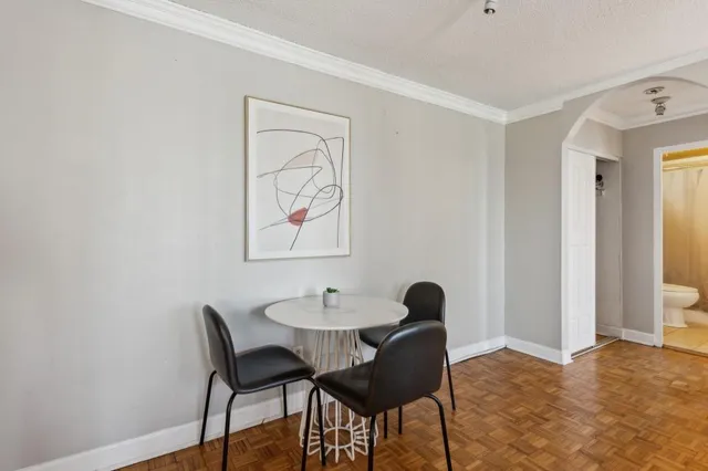 a view of a dining room with furniture and wooden floor
