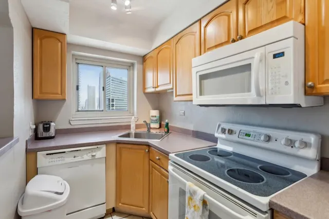 a kitchen with a stove microwave and sink