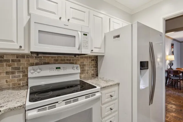 a stove top oven sitting inside of a kitchen