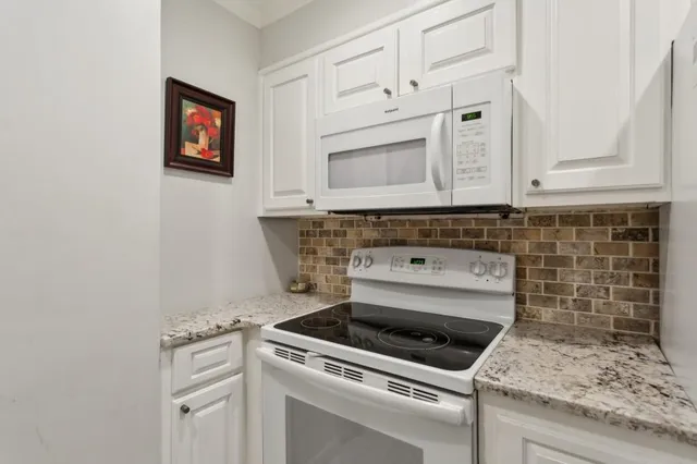 a stove top oven sitting inside of a kitchen