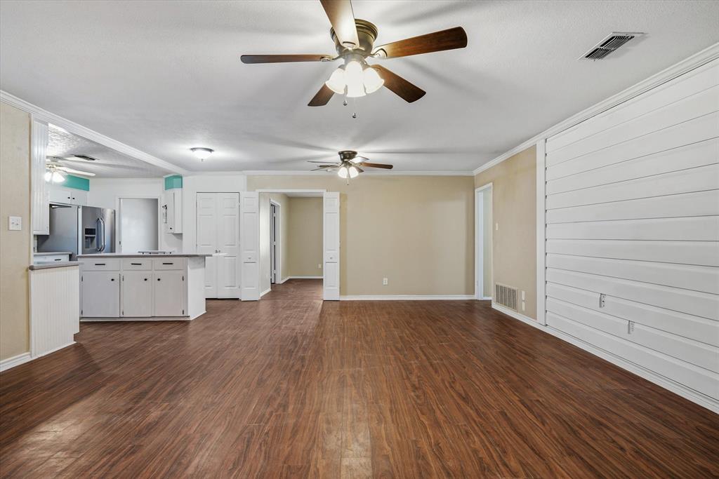 1729 Elliot Drive Canton, TX 75103 - Photo 10 of 40 living room with dark wood-style flooring, crown molding, and ceiling fan