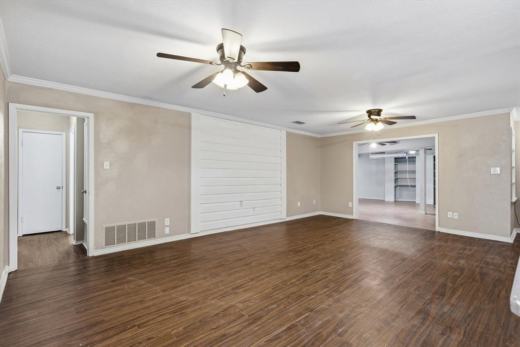 1729 Elliot Drive Canton, TX 75103 - Photo 11 of 40 living room featuring crown molding, a ceiling fan, and dark wood-type flooring