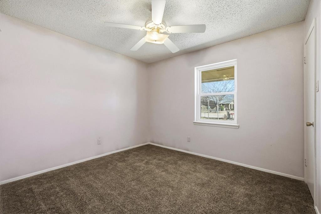 1729 Elliot Drive Canton, TX 75103 - Photo 15 of 40 Empty room with carpet, a textured ceiling, and ceiling fan