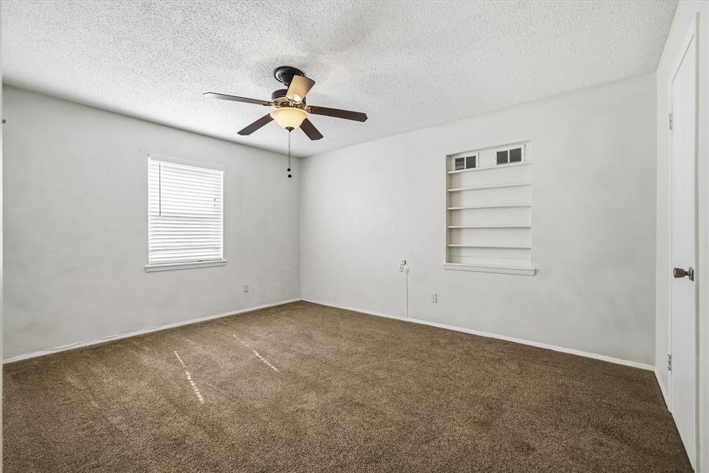 1729 Elliot Drive Canton, TX 75103 - Photo 17 of 40 Empty room with built in features, a textured ceiling, a ceiling fan, and carpet flooring