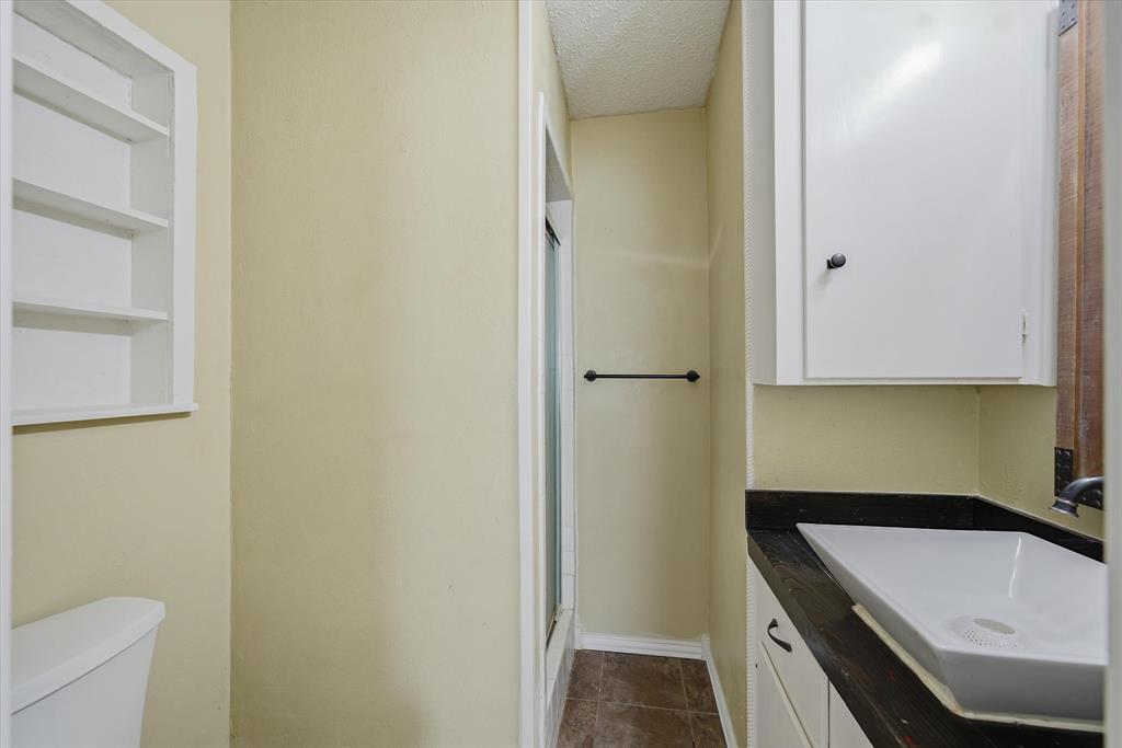 1729 Elliot Drive Canton, TX 75103 - Photo 18 of 40 ensuite Bathroom with a shower stall, vanity, and a textured ceiling