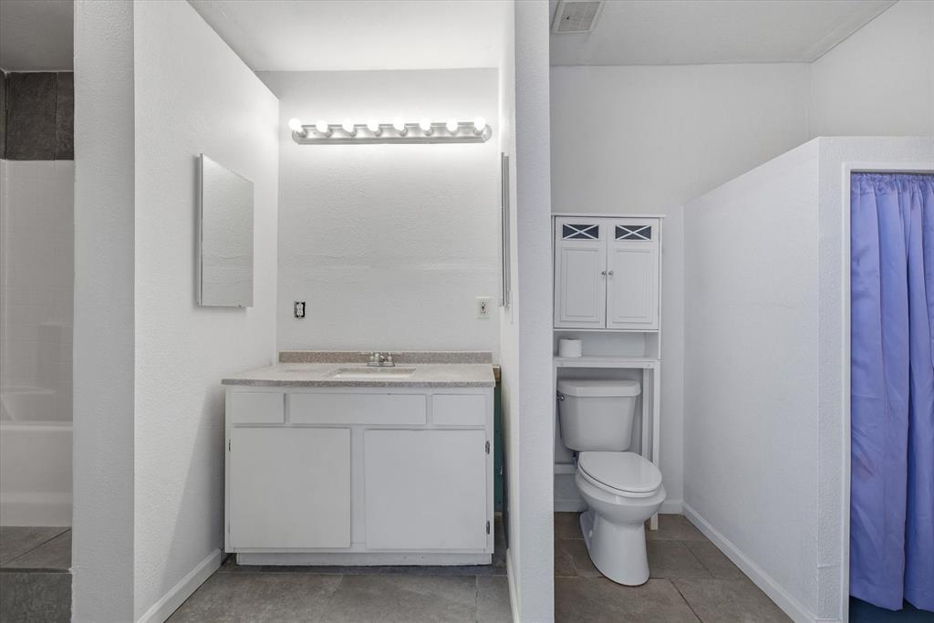 1729 Elliot Drive Canton, TX 75103 - Photo 32 of 40 Bathroom featuring vanity, shower / bath combination, and light tile patterned floors
