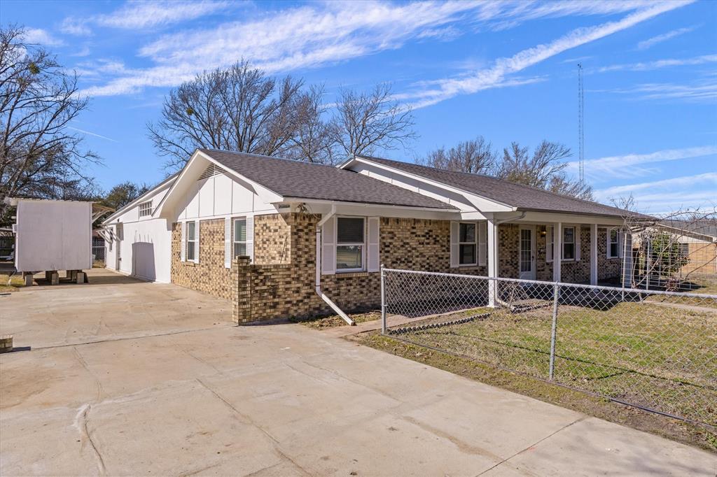 1729 Elliot Drive Canton, TX 75103 - Photo 38 of 40 Ranch-style home featuring driveway, brick siding, a fenced front yard, roof with shingles, and a porch