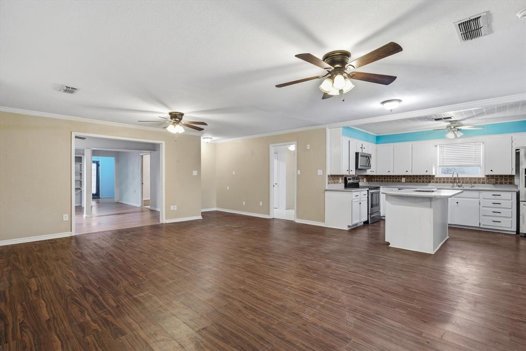 1729 Elliot Drive Canton, TX 75103 - Photo 39 of 40 Kitchen with open floor plan, white cabinets, dark wood-style flooring, a center island, and stainless steel appliances
