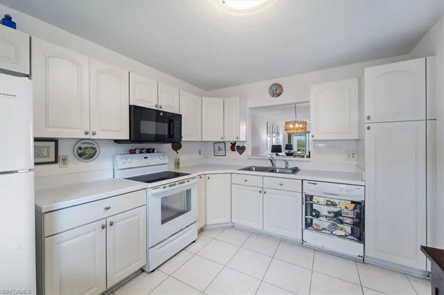 a kitchen with cabinets stainless steel appliances and a sink