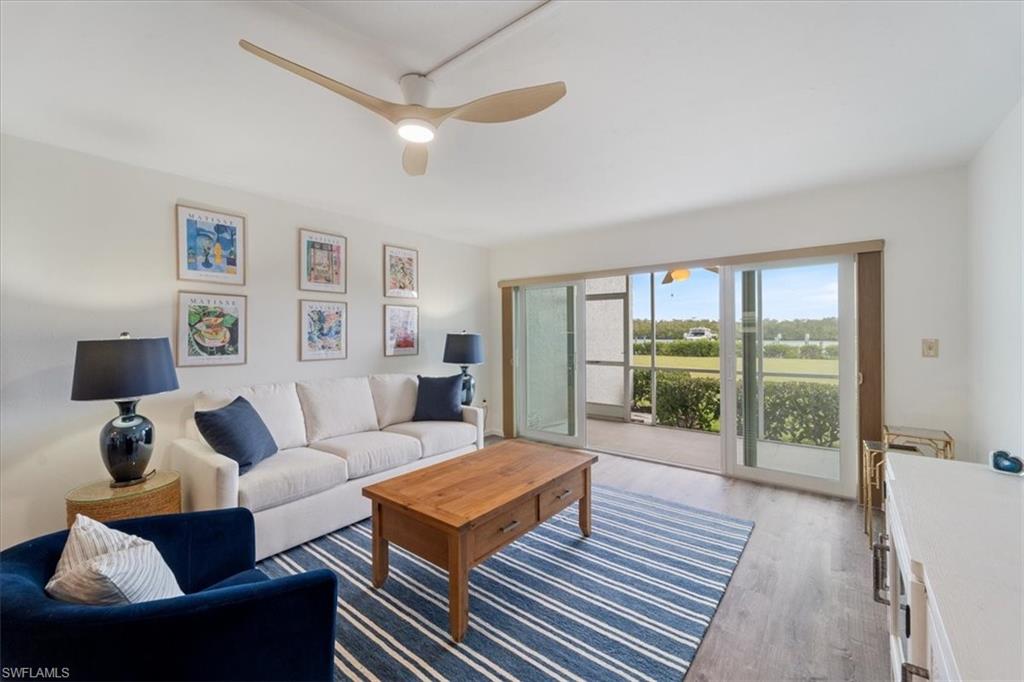 307 Goodlette-Frank Road, Unit B202 Naples, FL 34102 - Photo 4 of 21 a living room with furniture and a large window