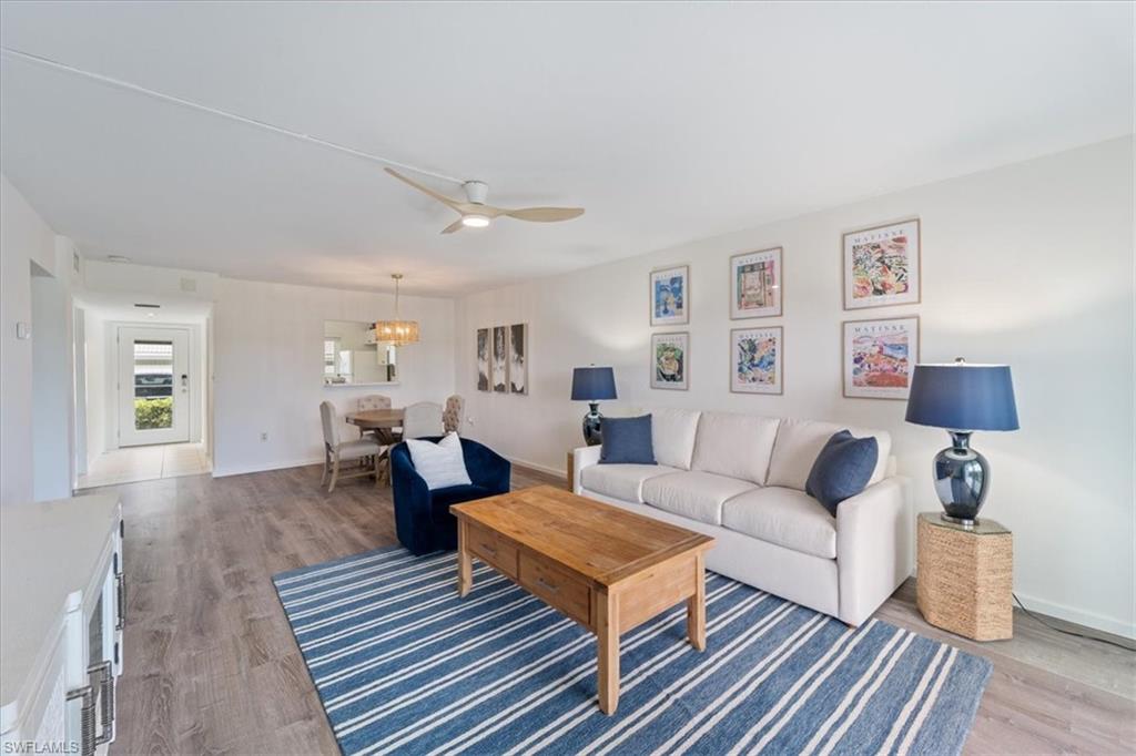 307 Goodlette-Frank Road, Unit B202 Naples, FL 34102 - Photo 5 of 21 a living room with furniture and a wooden floor