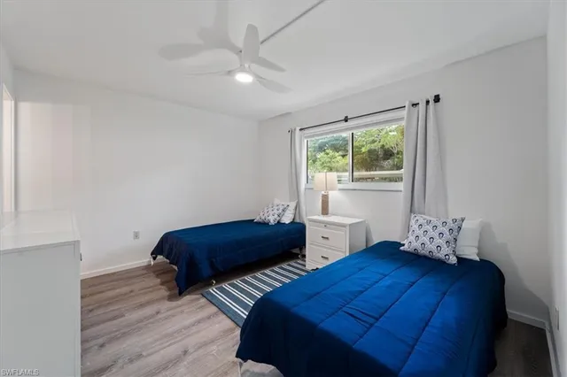 a bedroom with two beds and a window