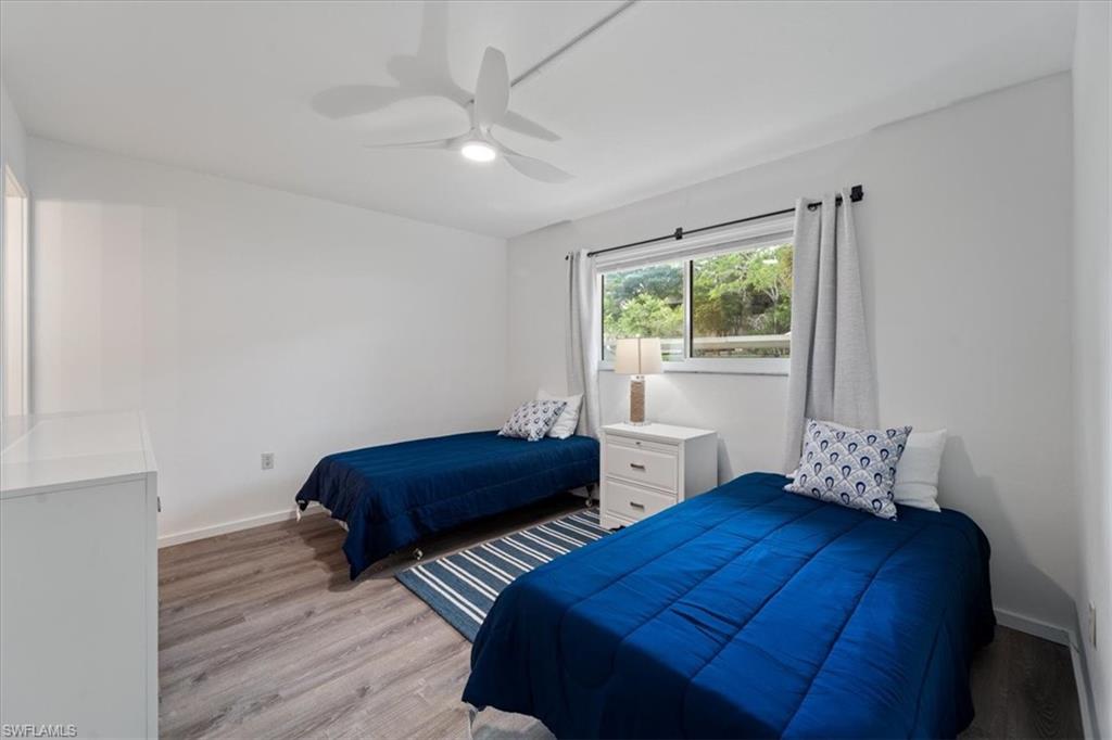 307 Goodlette-Frank Road, Unit B202 Naples, FL 34102 - Photo 9 of 21 a bedroom with two beds and a window