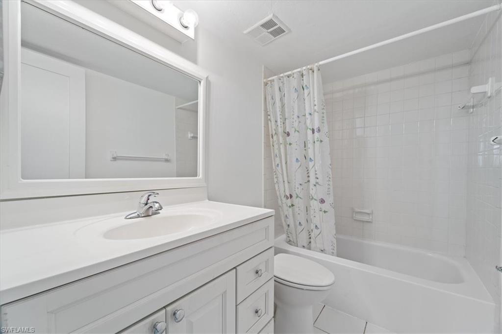 307 Goodlette-Frank Road, Unit B202 Naples, FL 34102 - Photo 10 of 21 a bathroom with a sink a toilet and shower